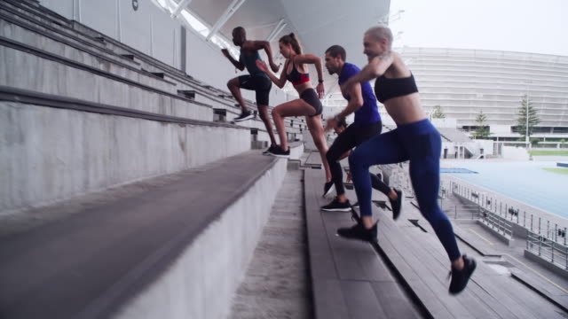 4k video footage of a group of athletes running up a staircase at a sports arena